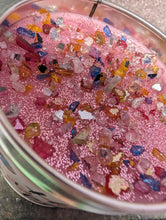 Load image into Gallery viewer, Pink candle with colorful glittery crystals in a container

